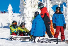 Snowboarders with their snowboard coach